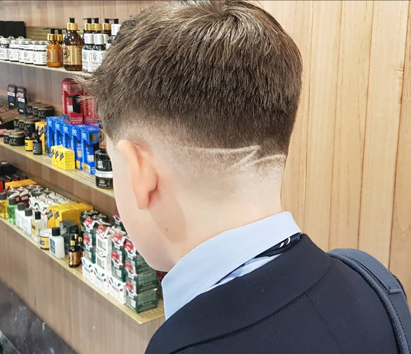 Clean textured haircut for a young client at Al Barber Shop