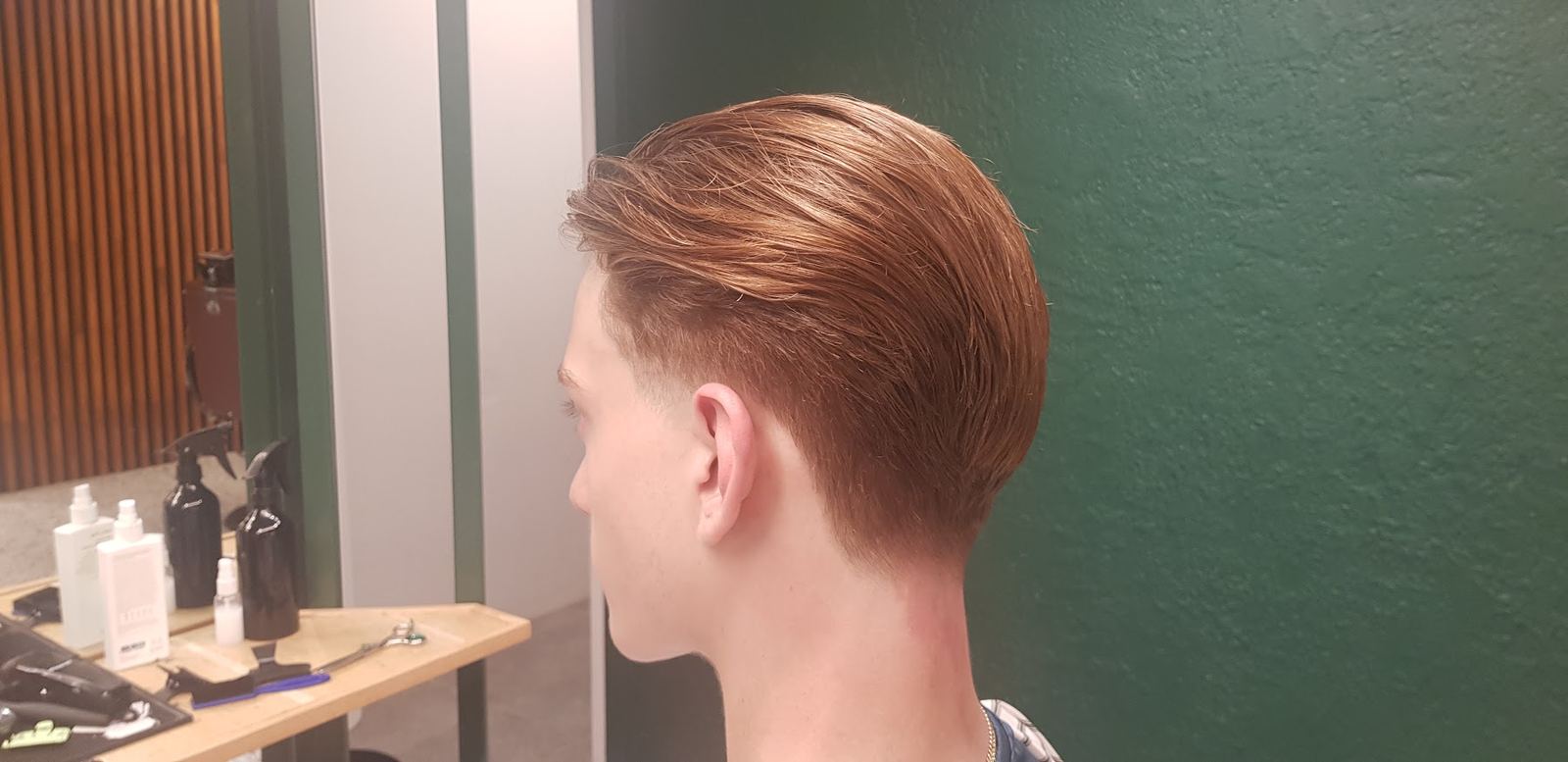 Classic side-part haircut finished by Alan